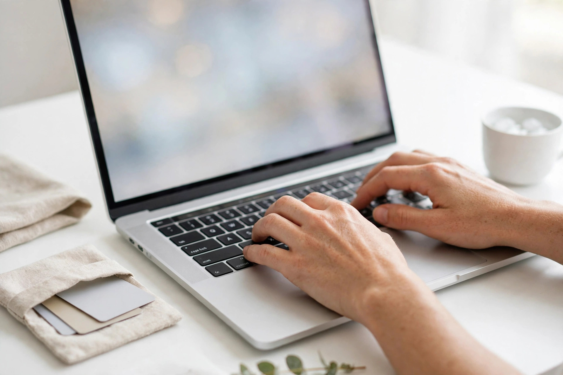 Hands typing at a laptop checkout